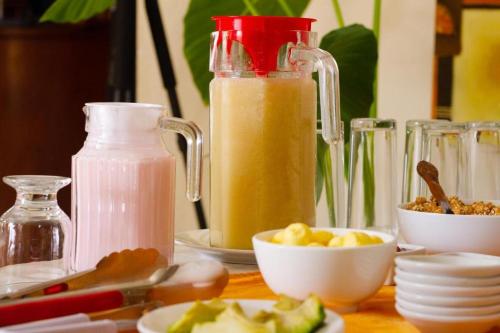 a table with jars of juice and a bowl of food at Astorga Hotel Arequipa in Arequipa