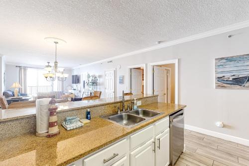 a kitchen with a sink and a living room at Sea Kastle in Panama City Beach