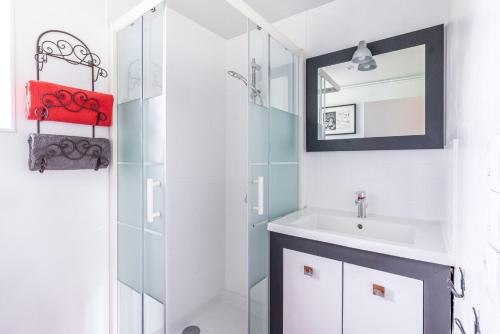 a bathroom with a sink and a mirror at La Villauvert - Cottage in Saint-Martin-sur-Oust