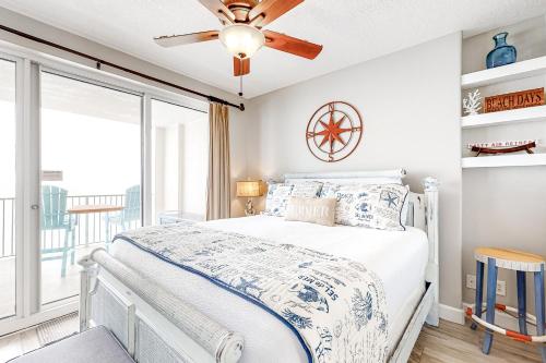 a bedroom with a bed and a large window at Sea Kastle in Panama City Beach