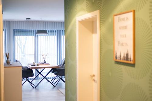 a room with a table and a room with a door at Lindenberg Apartments in Wernigerode