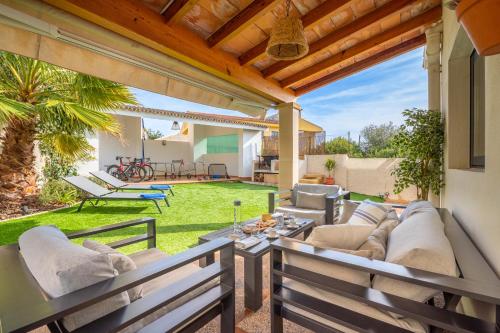 a patio with a couch and a table at Villa Ca'n Alonso - Families & Athletes Only in Palma de Mallorca