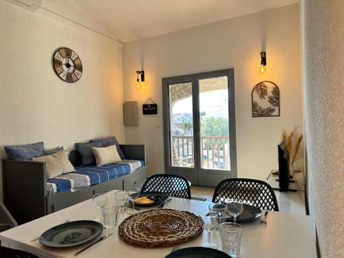 un salon avec une table et un lit dans l'établissement Appartement Duplex 4pers Climatisé - Locations VLD Camargue, à Saintes-Maries-de-la-Mer