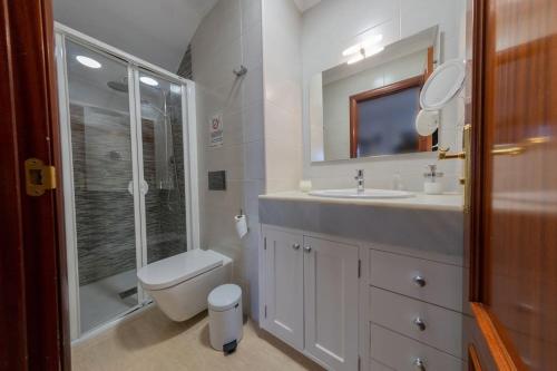 a bathroom with a toilet and a sink and a shower at Casa Paula, Costa Teguise in Costa Teguise