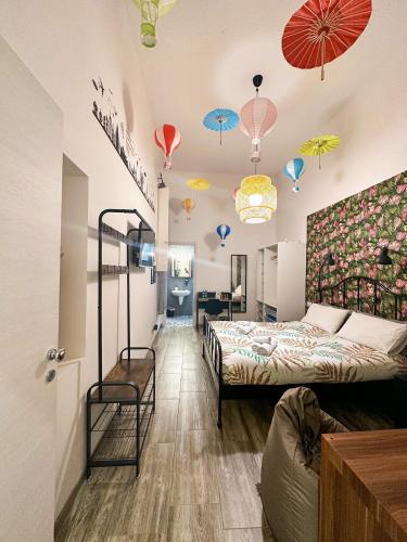a room with two beds and umbrellas on the ceilings at Kofler GuestHouse in Barletta