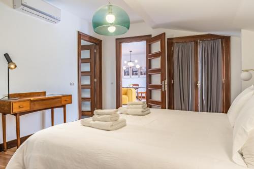 a bedroom with a bed with towels on it at Apartament 6 - By WeHost in Funchal