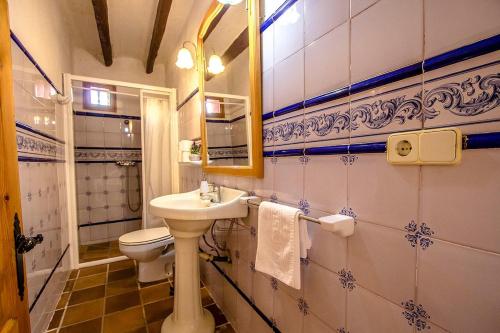 a bathroom with a sink and a toilet and a mirror at Catalunya Casas Country Chateau for 22 persons - close to Sitges! in Les Masuques