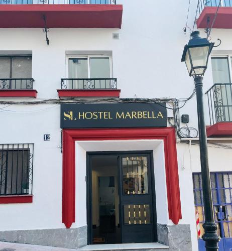 a building with a red door and a street light at SL Marbella in Marbella
