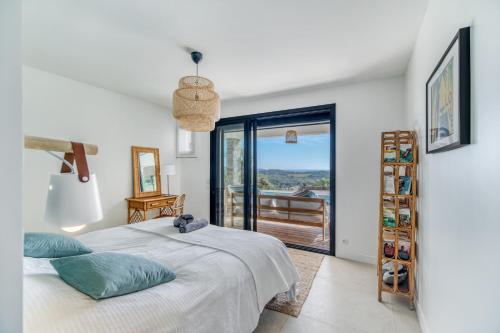 1 dormitorio con 1 cama y balcón en Villa 250m 8 adultes 4 enf vue mer, en La Croix-Valmer