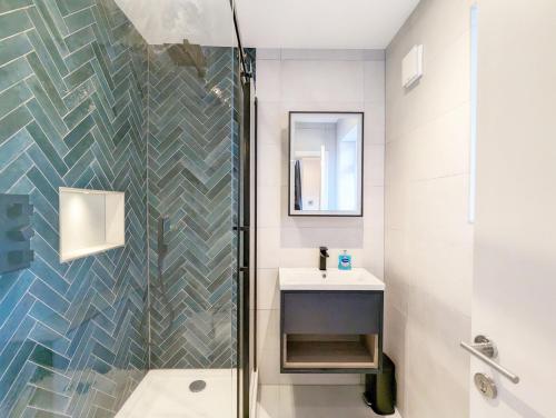 a bathroom with a shower and a sink at Malthouse Cottage in West Wittering