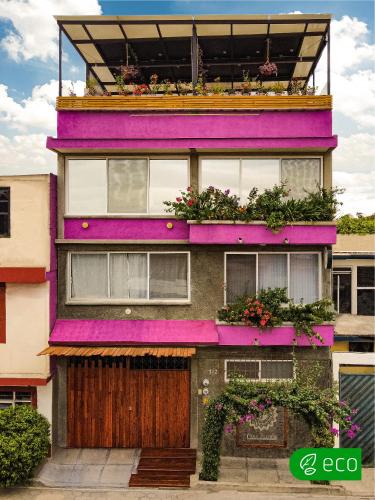 a purple building with flower boxes on it at Casa Flora Handmade Hotel in Atlixco