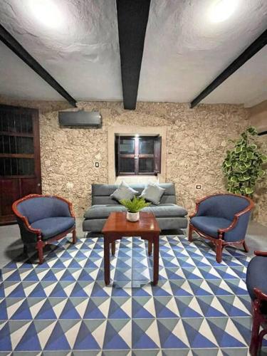 a living room with a couch and two chairs and a table at Casa Nardo Planta Baja in Valladolid