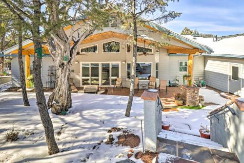 a home with a covered porch in the snow at Patio and Forest View Peaceful Show Low Home in Show Low