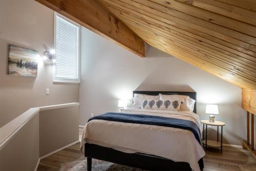 a bedroom with a large bed with a wooden ceiling at Escape to Ptarmigan Village 9 in Whitefish
