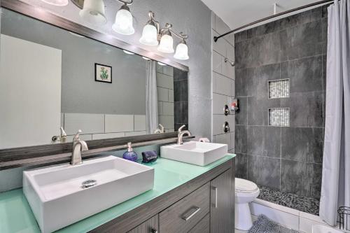 a bathroom with two sinks and a mirror at San Antonio Retreat, Close to Seaworld! in San Antonio