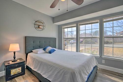 a bedroom with a large bed with a lamp and windows at San Antonio Retreat, Close to Seaworld! in San Antonio