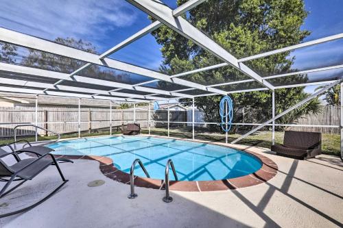 a swimming pool with a pergola over it at Family Home with Lanai and Yard in Port Richey! in Port Richey