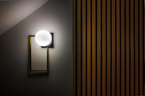 a light on the side of a wall at Next To Sea in Crotone
