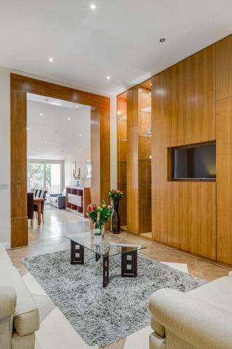 a living room with a couch and a table at Care Property London- Apartments in London