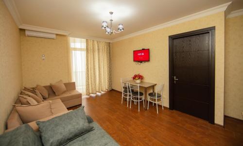 a living room with a couch and a table at Sea Towers Suite in Batumi