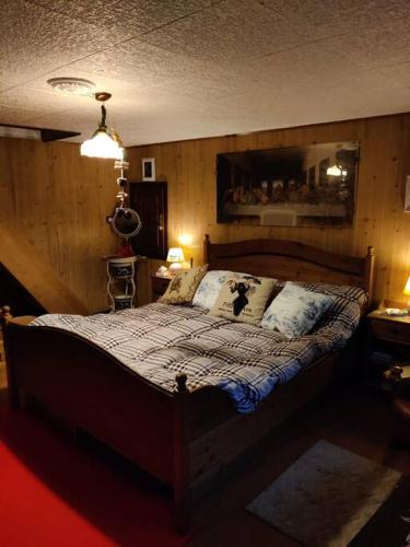 a bedroom with a bed in a room with wooden walls at The Golden Eagle - Chalet a Champdepraz in Aosta