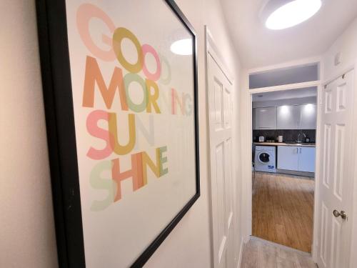 a door with a sign that says go more than sunshine at COSY 2 Bed APARTMENT NEARBY TRAIN STATION! in Watford