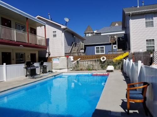 a swimming pool in front of a house at Flamingo Inn in Seaside Heights