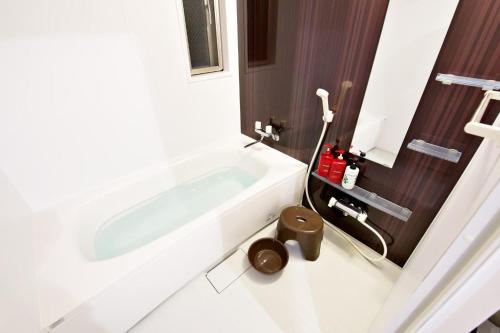 a white bathroom with a tub and a sink at Hana house - Vacation STAY 92529v in Ginowan