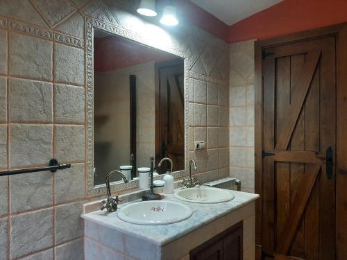 baño con 2 lavabos y espejo grande en Vivienda Turística El Acebuchal, en Ubrique