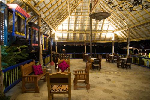 a room with tables and chairs in a building at Hotel San Antonio del Cerro in Pereira