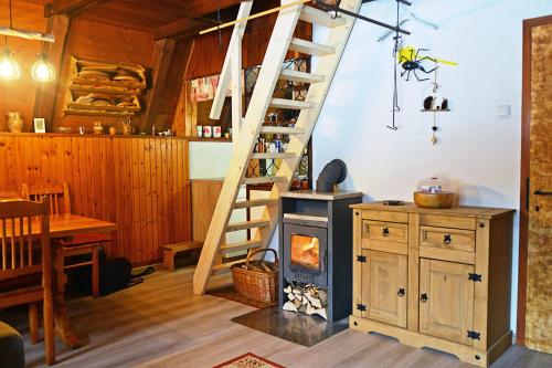 a kitchen with a staircase and a stove in a room at Hiša Pr Valter in Jesenice