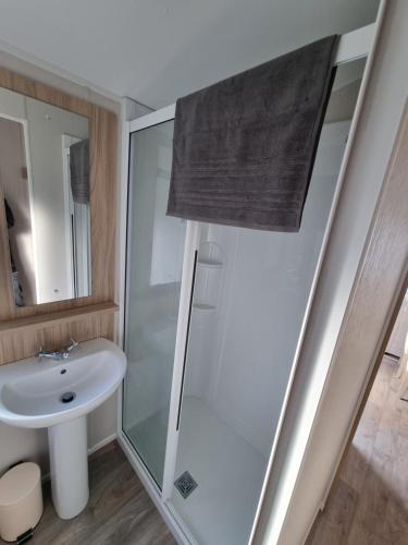 a bathroom with a shower and a sink at "Malton" LG27 Pet Friendly in Shanklin