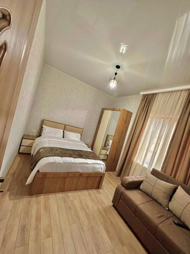 a bedroom with a bed and a couch at Wonder Hill group in Bakuriani