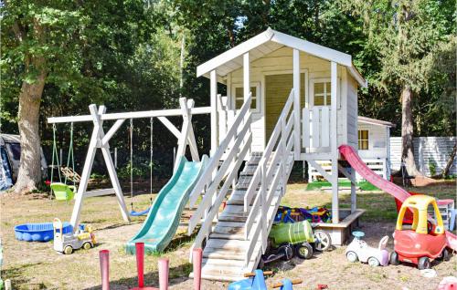 a playground with a play house and play equipment at 1 Bedroom Beautiful Home In Pobierowo in Pobierowo