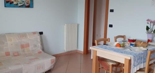 a room with a table and a chair with a bowl of fruit on it at Agriturismo L'Uliveto in Gargnano