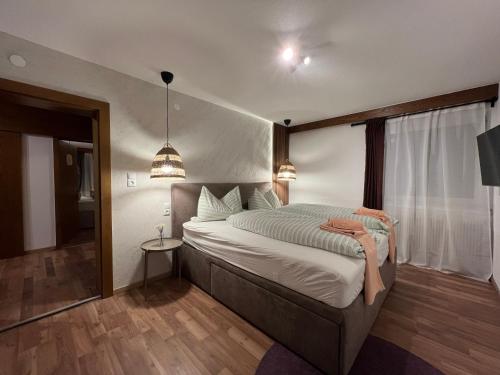 a bedroom with a large bed in a room at Haus Anton Sölden - Apartments & Zimmer in Sölden