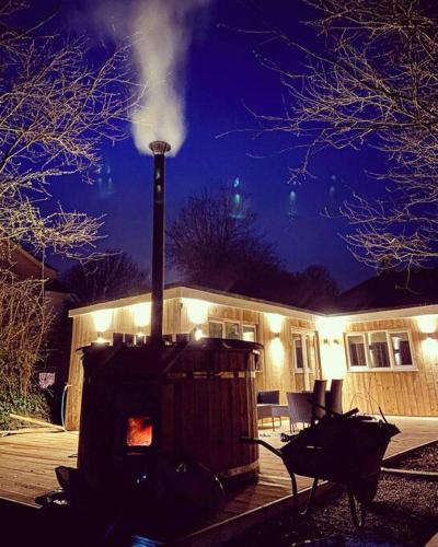a building with a smoke stack in front of it at Hunting Gate Lodge in Redruth