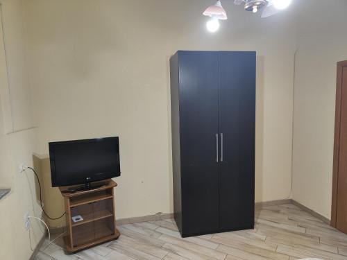 a black cabinet in a room with a tv at Oikos in Boscotrecase