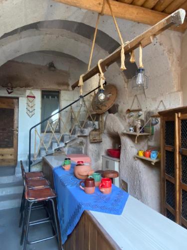 a kitchen with a counter with a blue table at Pigeon Hotel Cappadocia in Uchisar