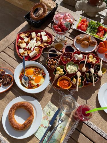 a table topped with plates of food and bowls of food at Pigeon Hotel Cappadocia in Uchisar