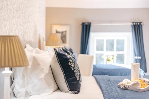 a bedroom with a bed with black and white pillows at Ironbridge View Townhouse - Stunning view of the Iron Bridge UK WINNER 2024 'MOST PICTURESQUE SELF-CATERING HOLIDAY HOME' of the year' & WINNER '2024 BEST HOLIDAY HOME IN SHROPSHIRE' in Ironbridge