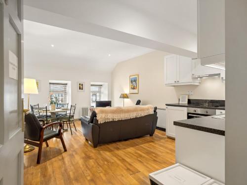 uma cozinha e sala de estar com um sofá e uma mesa em Town centre apartment, Clifden em Clifden