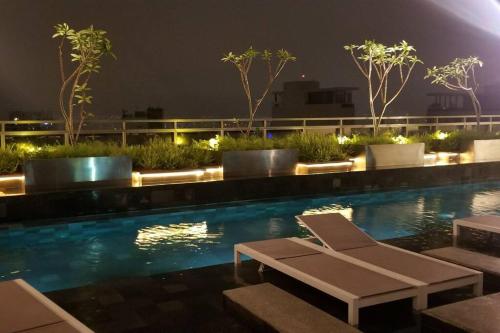 a swimming pool with a chaise lounge and avisor at Viva Sampa! in Sao Paulo