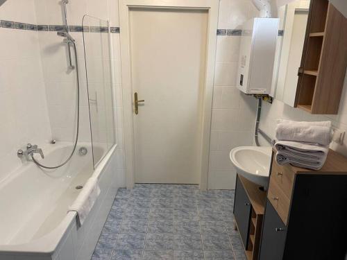 a bathroom with a tub and a sink and a shower at Dachterrasse für 4 Personen in Vienna