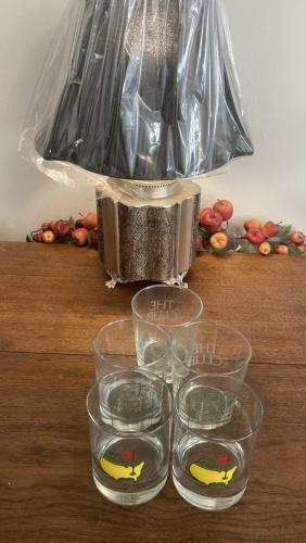 a group of glasses sitting on a table with a bag at THE Clubhouse MASTERS GOLF THEMED 1 KING BED 1 BATH FURNISHED APARTMENT FULL SIZE KITCHEN FULL SIZE LEATHER PULL OUT SLEEPER SOFA IN LIVING ROOM & FULL SIZE LEATHER SOFA 1 GIG FIBER INTERNET DIRECTV PREMIUM PACKAGE ALL SPORTS & MOVIE CHANNELS & DVR in Columbia