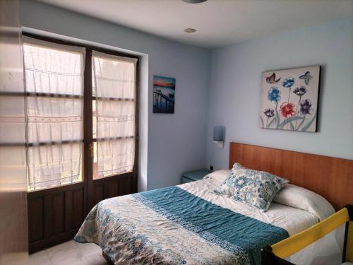 a bedroom with a bed and a window at Don Camino Premium in Villalcázar de Sirga