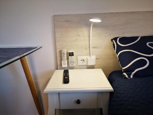 a bed room with a table with a remote control on it at Sunny studio La Mata beach in Torrevieja