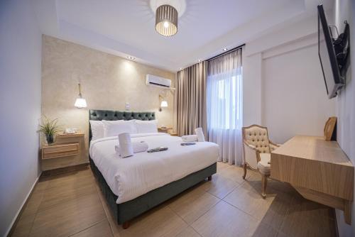 a hotel room with a large bed and a desk at Anixi Hotel by AP in Athens