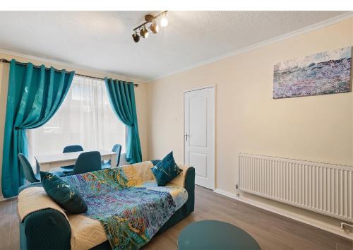 a living room with a couch and a table at Three Bed near London excel in Abbey Wood