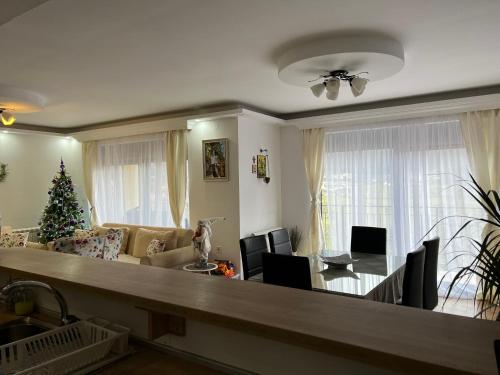 a living room with a christmas tree and a dining table at Montana House Njeguši in Cetinje